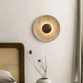 Aplique de pared de travertino redondo Wabi-Sabi Ø25 cm para dormitorio