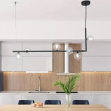 Lamparas sobre isla cocina diseño lineal con esferas modernas